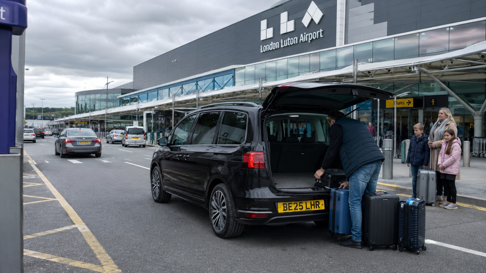 Black VW Sharan MPV6 dropping a family with luggage at London Luton Airport terminal drop-off zone 