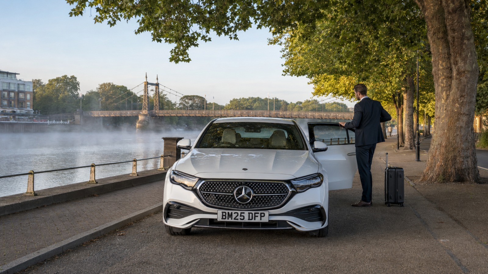 White Mercedes E-Class taxi at Bedford Embankment for a Luton Airport transfer, River Great Ouse in view  