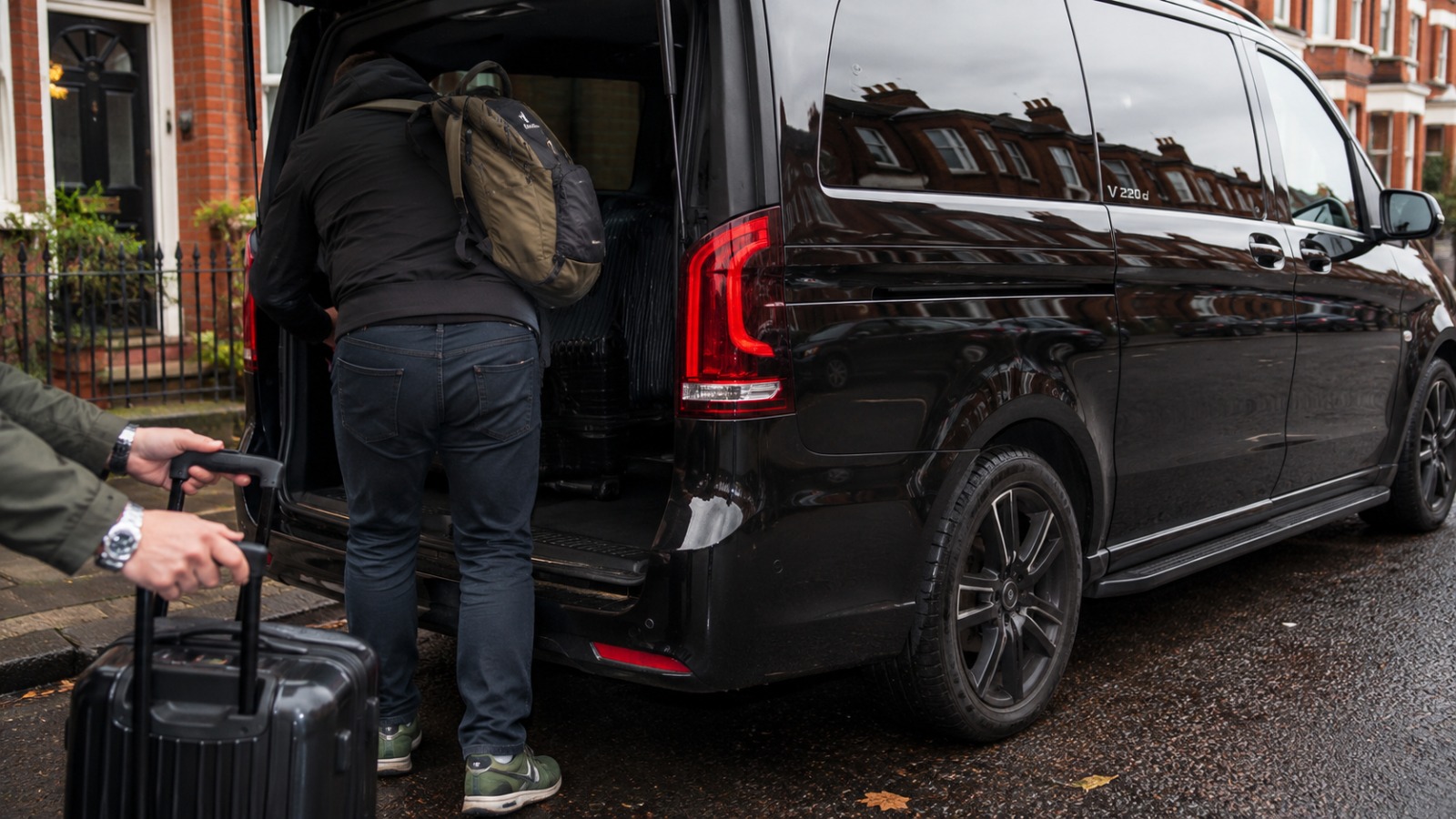 Passengers self-loading 8-seat minibus at Aigburth Liverpool Victorian terrace on overcast midday for Manchester Airport