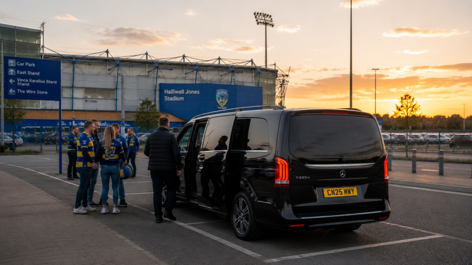 Rugby fans in Warrington Wolves colours boarding 8-seat minibus at Halliwell Jones Stadium for Manchester