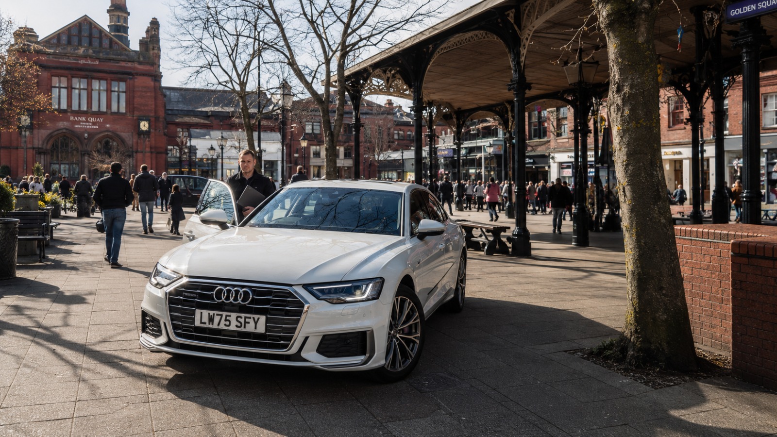 White Audi saloon at Warrington Golden Square Bridge Street Saturday morning for Manchester Airport
